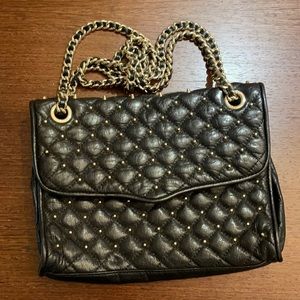 Rebecca Minkoff black quilted handbag with gold studs and chain strap detail.